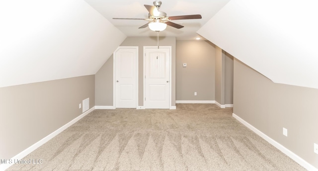 additional living space featuring vaulted ceiling, a ceiling fan, carpet floors, and baseboards