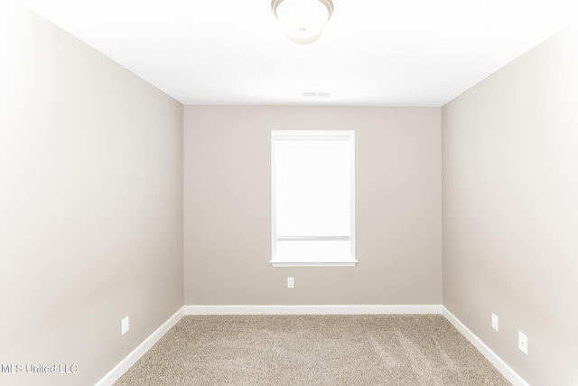 carpeted empty room with baseboards