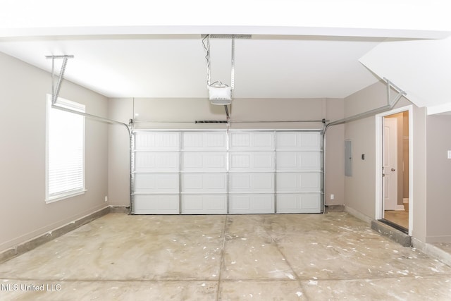 garage with electric panel, a garage door opener, and baseboards