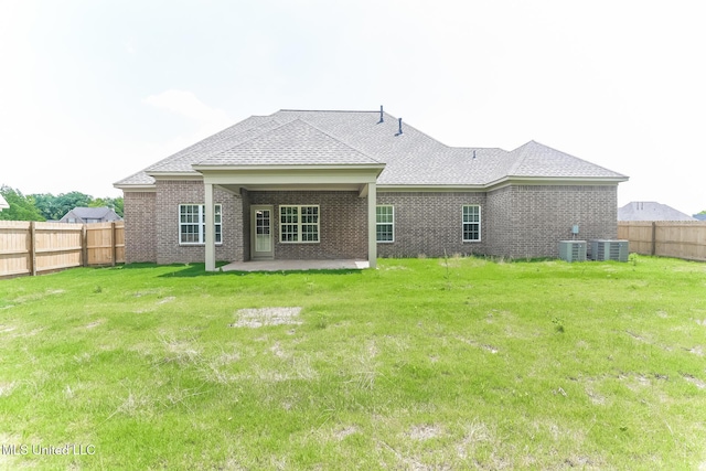 rear view of house with a patio, roof with shingles, brick siding, and cooling unit