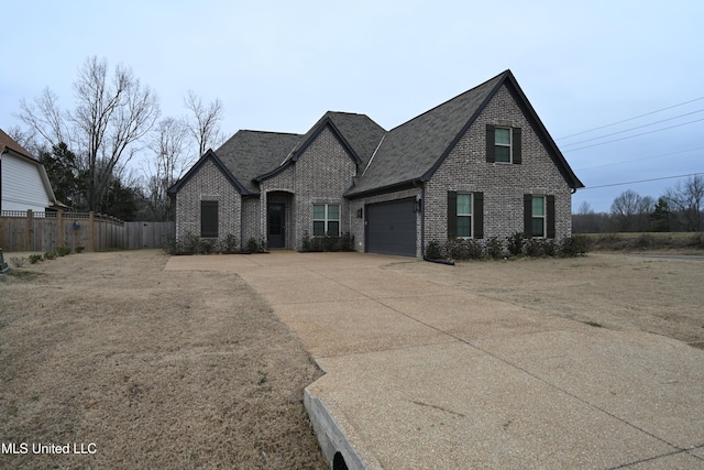 french country inspired facade featuring a garage