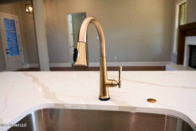 room details with light stone counters and sink