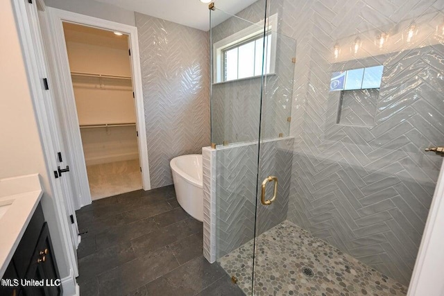 bathroom with vanity and separate shower and tub