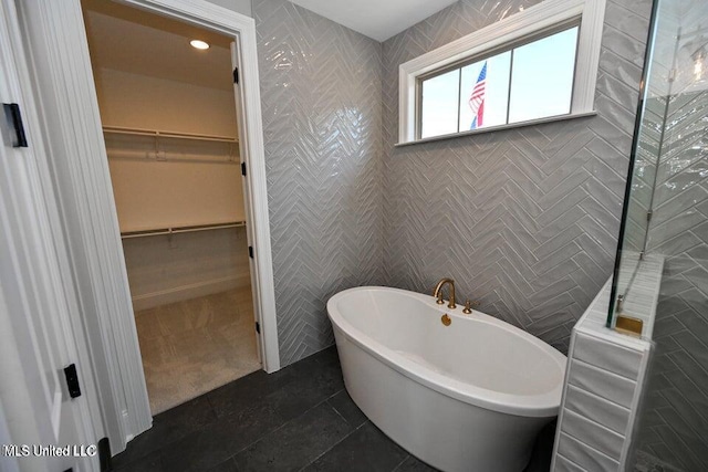 bathroom featuring a bathing tub and tile patterned flooring