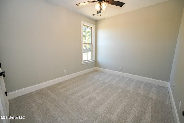 empty room with light colored carpet and ceiling fan