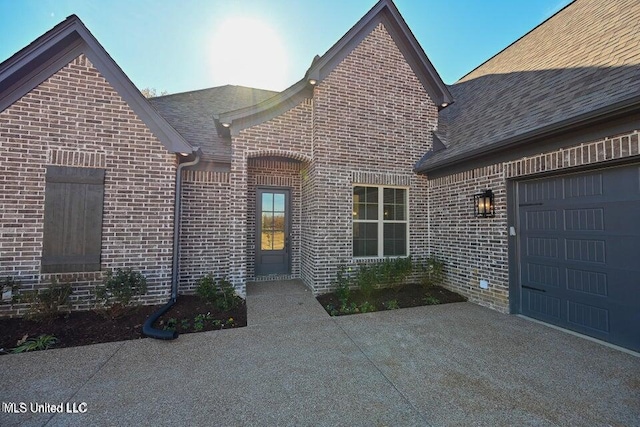 view of exterior entry featuring a garage