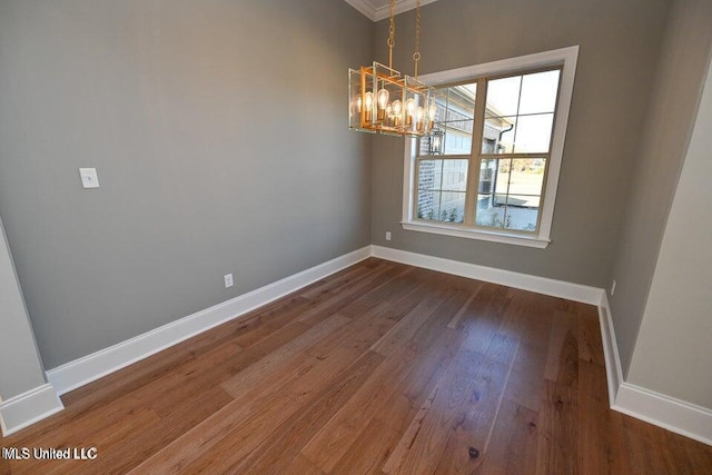 unfurnished dining area featuring dark wood-type flooring and an inviting chandelier