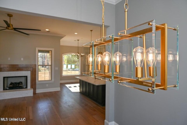 interior space featuring hardwood / wood-style flooring, ceiling fan, and crown molding