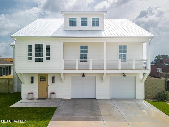 405 Mason Ave, Long Beach, MS 39560 - view of front of home featuring concrete driveway, a garage, a standing seam roof, and a metal roof
