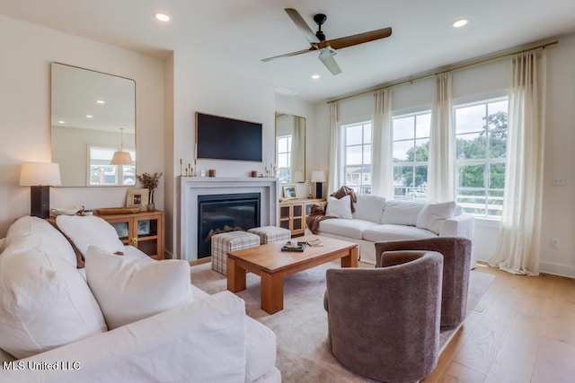 405 Mason Ave, Long Beach, MS 39560 - living room with plenty of natural light, recessed lighting, a glass covered fireplace, a ceiling fan, and light wood-style flooring
