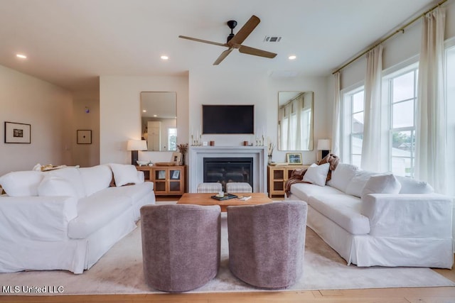 405 Mason Ave, Long Beach, MS 39560 - living area featuring healthy amount of natural light, a ceiling fan, a glass covered fireplace, and recessed lighting