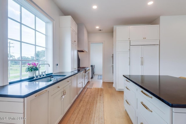 405 Mason Ave, Long Beach, MS 39560 - kitchen with recessed lighting, light wood finished floors, white cabinets, and dark countertops