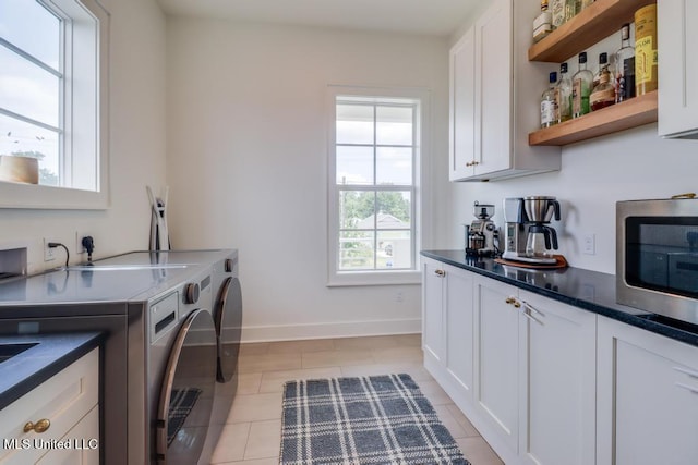 405 Mason Ave, Long Beach, MS 39560 - laundry room featuring washer and dryer, light tile patterned flooring, and bar area