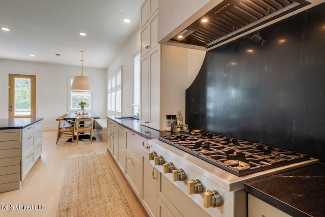 405 Mason Ave, Long Beach, MS 39560 - kitchen with stainless steel gas cooktop, premium range hood, dark countertops, recessed lighting, and light wood finished floors