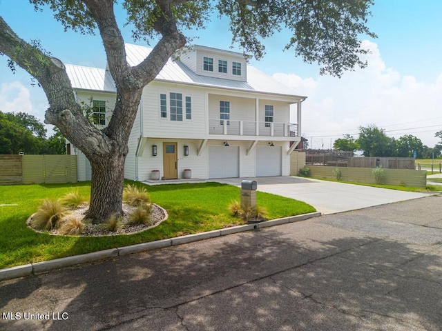 405 Mason Ave, Long Beach, MS 39560 - view of front of home featuring driveway, a garage, a balcony, and a metal roof