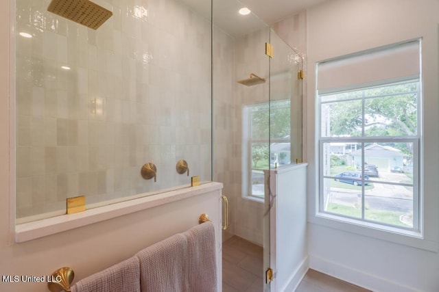 405 Mason Ave, Long Beach, MS 39560 - bathroom with tiled shower and tile patterned flooring