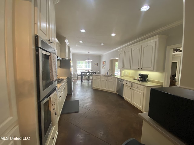 kitchen featuring crown molding, a peninsula, dishwasher, and white cabinetry