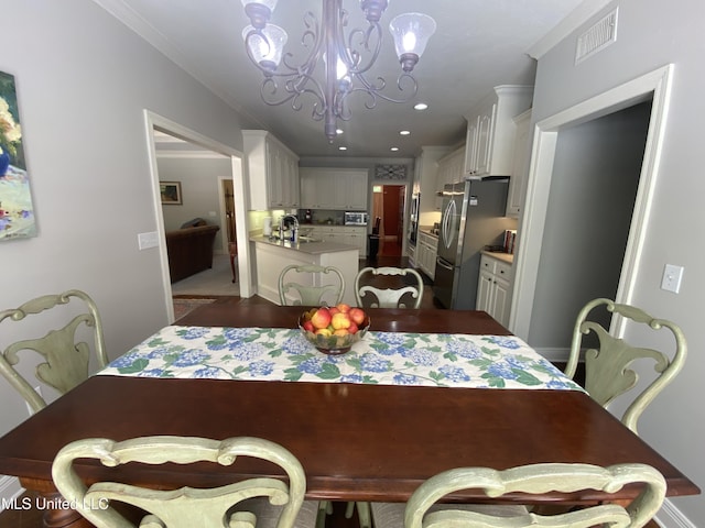 dining area featuring recessed lighting, a notable chandelier, visible vents, and ornamental molding
