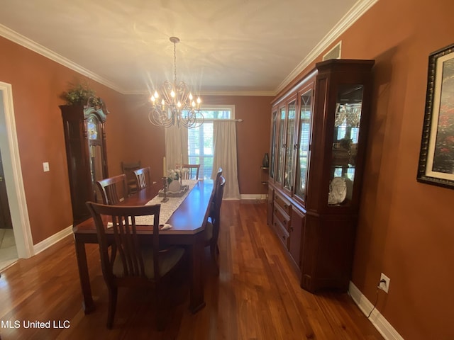 dining area featuring a chandelier, dark wood-style flooring, baseboards, and ornamental molding