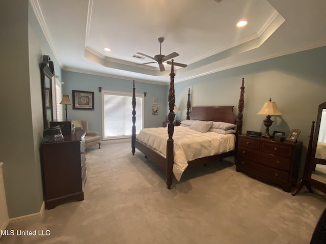 bedroom featuring light carpet, visible vents, crown molding, and a raised ceiling