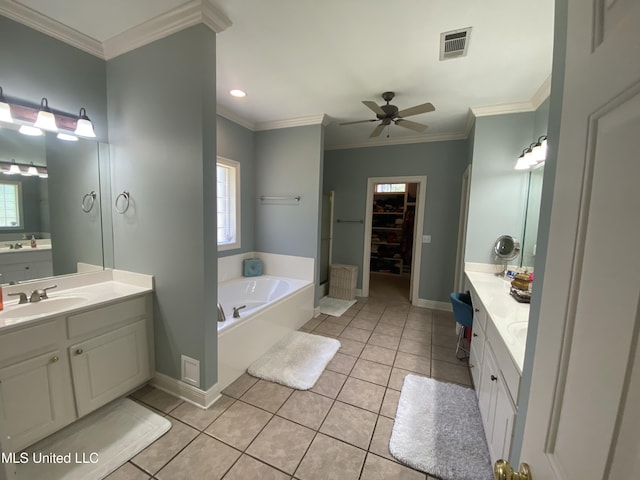 bathroom featuring a garden tub, ceiling fan, tile patterned flooring, visible vents, and a sink