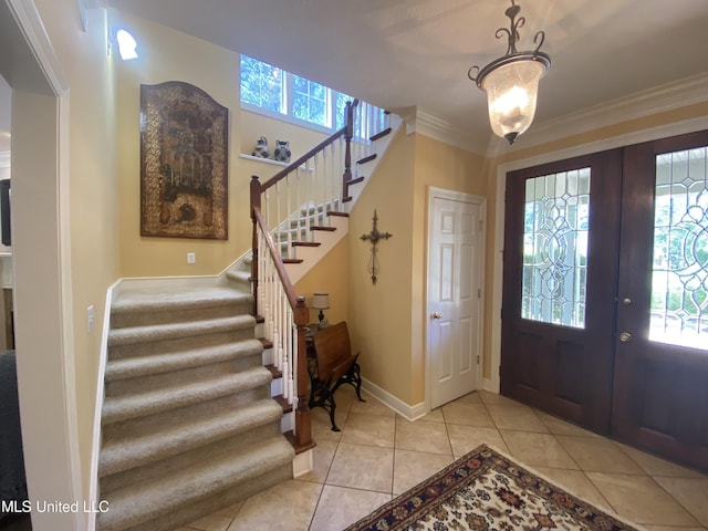 entrance foyer featuring french doors, stairway, and plenty of natural light