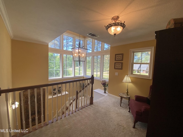living area featuring carpet flooring, visible vents, ornamental molding, and a healthy amount of sunlight