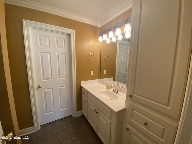 bathroom with tile patterned flooring, vanity, baseboards, and crown molding