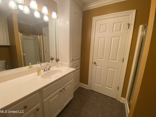 full bath with crown molding, vanity, tile patterned flooring, a stall shower, and baseboards