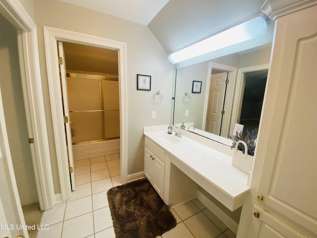 bathroom with shower / bath combination with glass door, tile patterned flooring, vaulted ceiling, and vanity