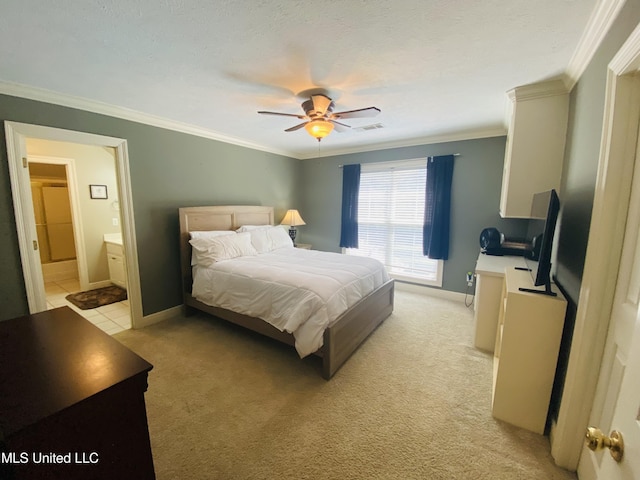 bedroom featuring baseboards, ornamental molding, light carpet, ensuite bathroom, and ceiling fan