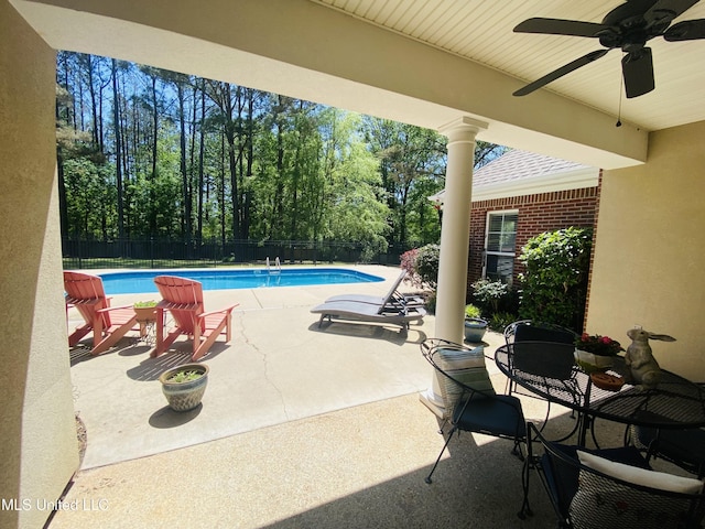 view of swimming pool featuring a fenced backyard, a ceiling fan, a patio, outdoor dining space, and a fenced in pool