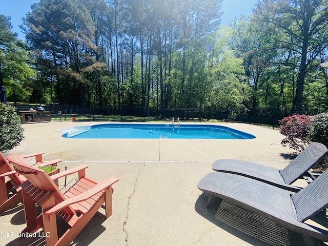 view of pool with a fenced in pool, a patio, and a fenced backyard