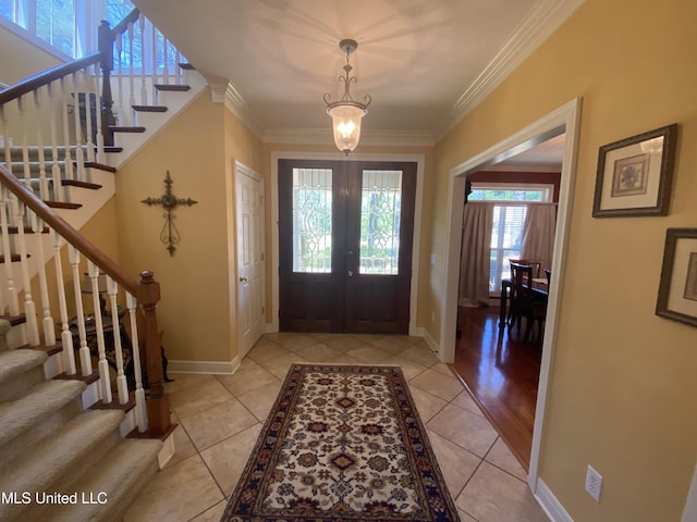 entryway featuring baseboards, ornamental molding, stairway, french doors, and light tile patterned floors