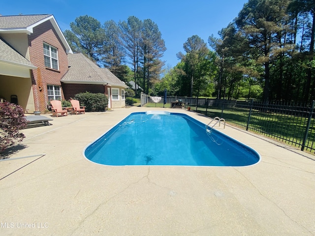 view of swimming pool featuring a fenced in pool, a patio, and fence
