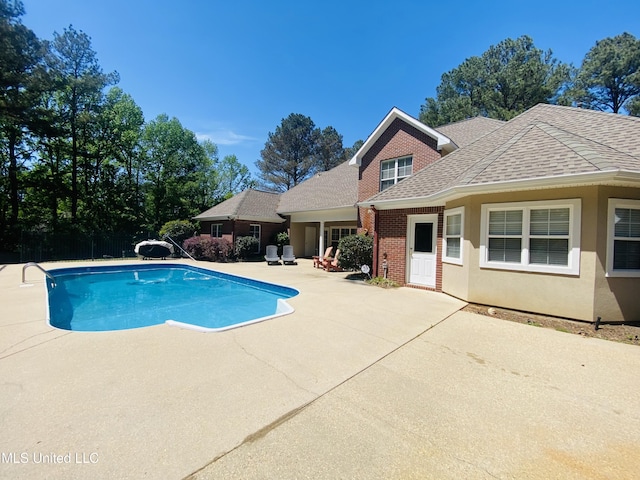 outdoor pool featuring a patio area