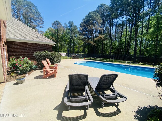 view of swimming pool featuring a fenced backyard, a fenced in pool, and a patio