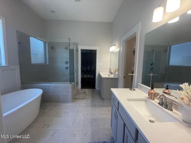 7228 Edgewater Dr, Olive Branch, MS 38654 - full bath with a shower stall, a freestanding bath, stone tile flooring, and two vanities