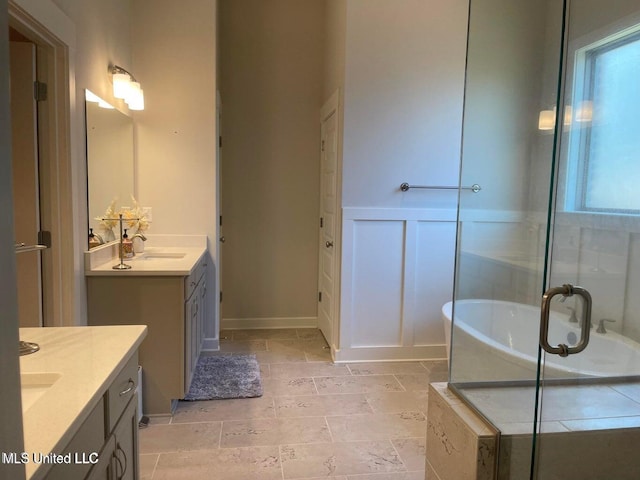 7228 Edgewater Dr, Olive Branch, MS 38654 - bathroom featuring two vanities, a tub, and a stall shower