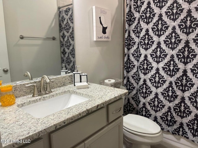 7228 Edgewater Dr, Olive Branch, MS 38654 - bathroom featuring toilet, vanity, and curtained shower