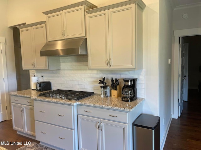 7228 Edgewater Dr, Olive Branch, MS 38654 - kitchen featuring under cabinet range hood, dark wood-style flooring, and tasteful backsplash