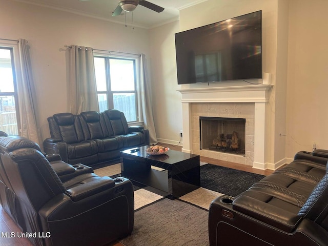 7228 Edgewater Dr, Olive Branch, MS 38654 - living room with a ceiling fan, a tiled fireplace, wood finished floors, baseboards, and ornamental molding