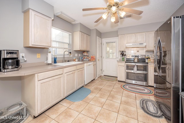 kitchen featuring appliances with stainless steel finishes, a textured ceiling, ceiling fan, sink, and light tile patterned floors