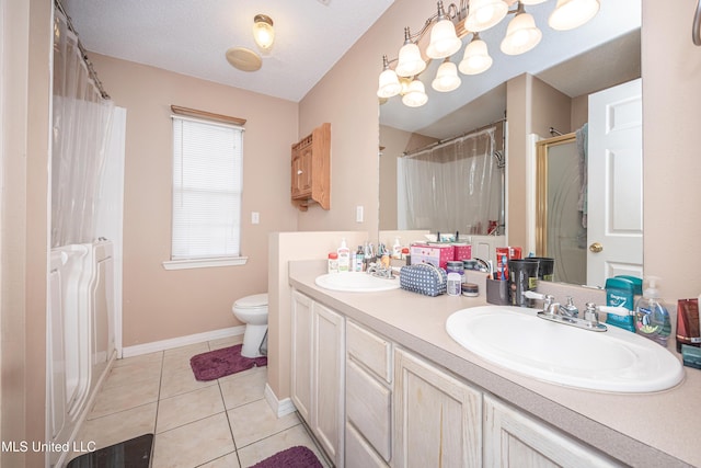 bathroom with curtained shower, tile patterned floors, a textured ceiling, toilet, and vanity