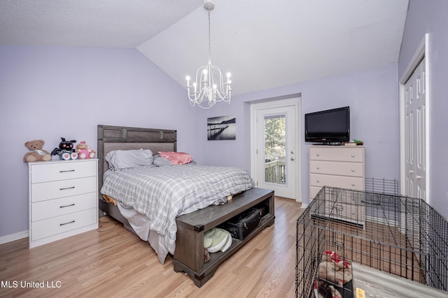 bedroom with access to exterior, a closet, light hardwood / wood-style floors, and lofted ceiling