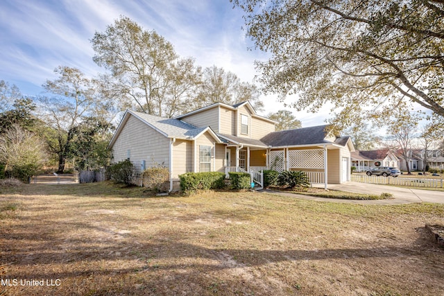 view of front property with a porch, a garage, and a front yard