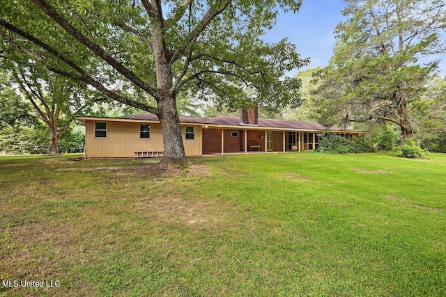 182 Brandon Williamsburg Rd, Mendenhall, MS 39114 - rear view of house with a chimney and a lawn