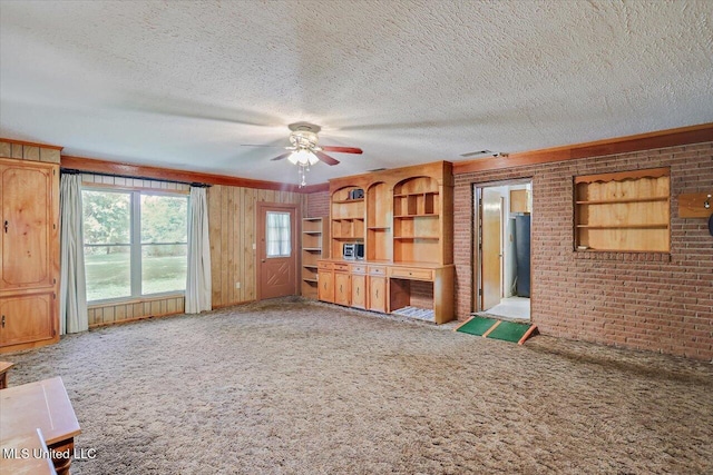 182 Brandon Williamsburg Rd, Mendenhall, MS 39114 - unfurnished living room with carpet flooring, a ceiling fan, brick wall, and a textured ceiling
