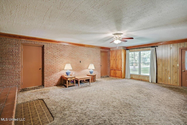182 Brandon Williamsburg Rd, Mendenhall, MS 39114 - sitting room with a ceiling fan, brick wall, carpet floors, and a textured ceiling