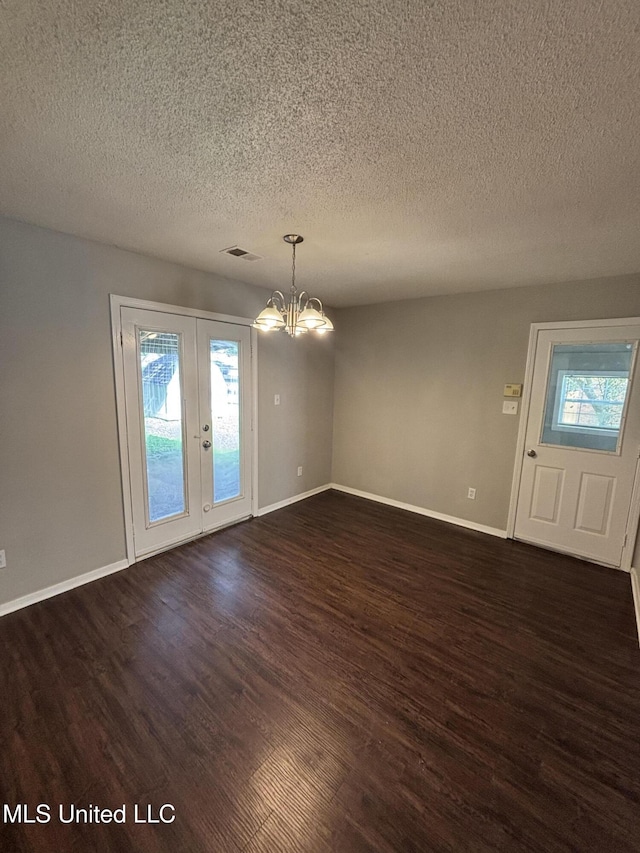 6405 Collinwood Rd, Horn Lake, MS 38637 - unfurnished dining area with french doors, a textured ceiling, visible vents, a notable chandelier, and dark wood-type flooring